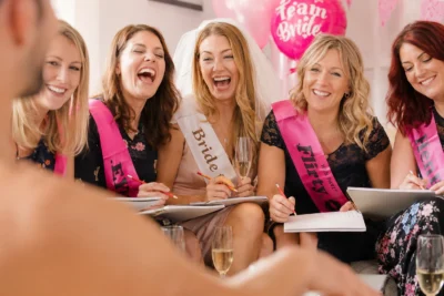Hens party guests laughing during a life drawing class