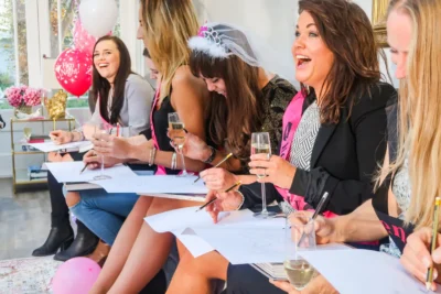 Hens sketching a butler during a life drawing class at a hen party